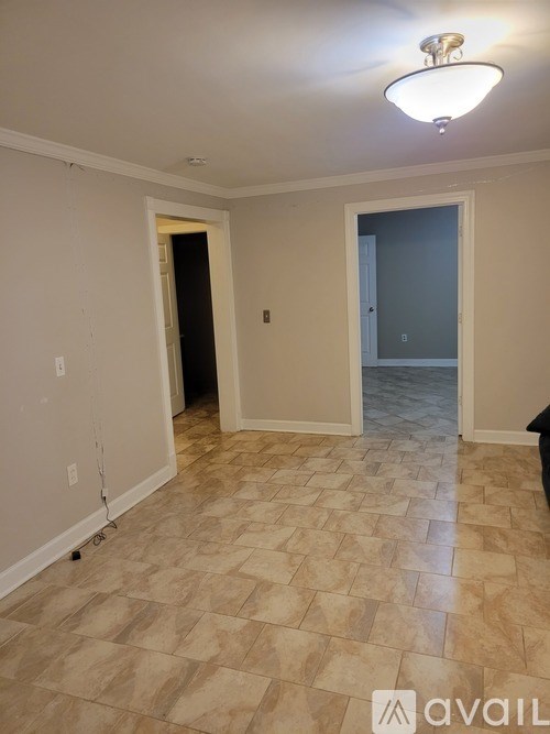 A room with a tiled floor and a ceiling light.