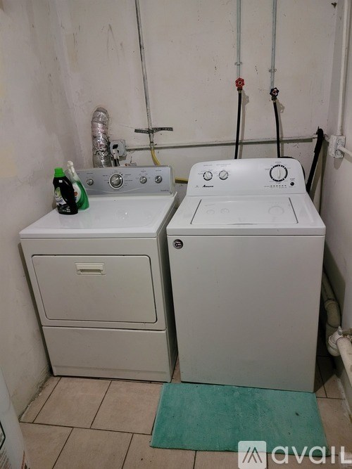 A white washing machine and dryer in a small laundry room.