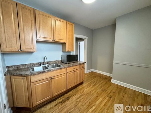 A kitchen with wooden cabinets and a granite countertop.