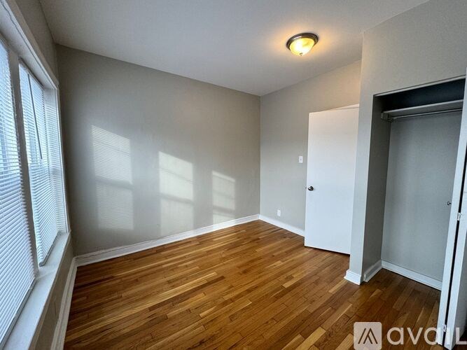 A room with wooden floors and a white door.