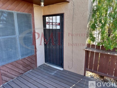 A house with a "For Rent" sign on the door.