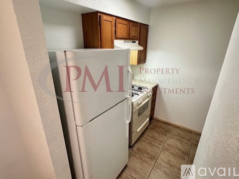 A kitchen with a refrigerator, stove, and oven.