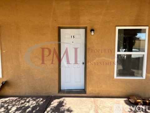 A brown house with a white door and window with a sign that says Property Investment.