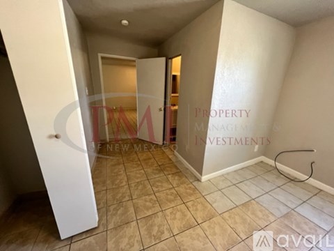 A hallway with a door on the left and a wall on the right with a sign that says "Property Management Investments".