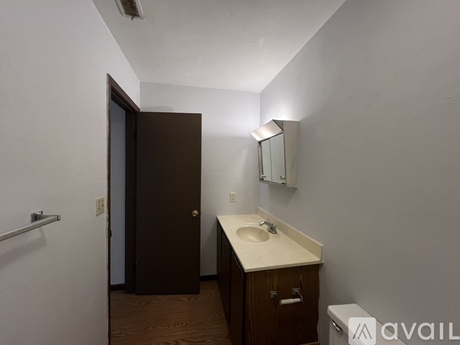 A bathroom with a sink, mirror, and toilet.