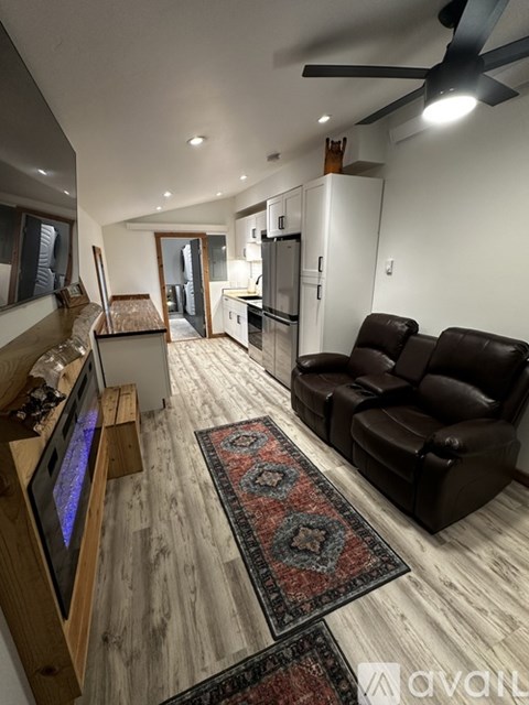 A living room with a television and two couches.