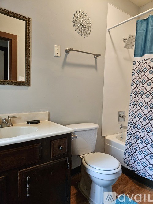 A bathroom with a toilet, sink, and shower.
