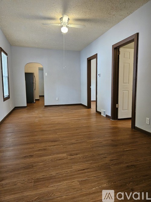 A room with wooden floors and white walls.