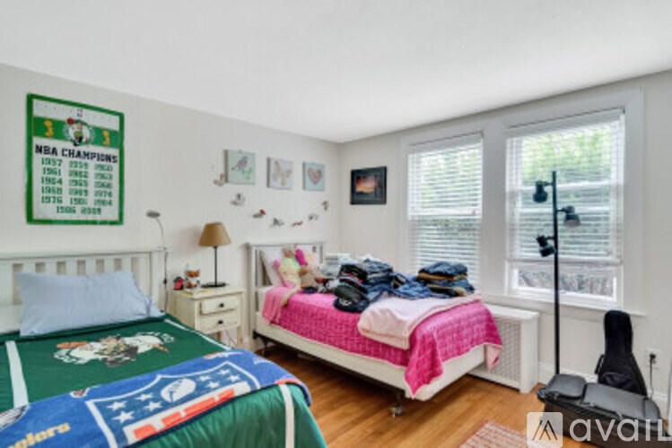 A bedroom with a poster of NBA champions on the wall.
