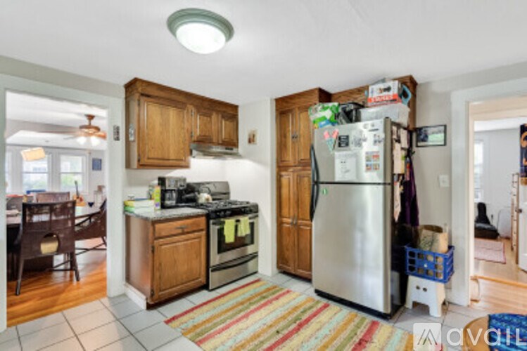 A kitchen with a refrigerator, oven, and sink.