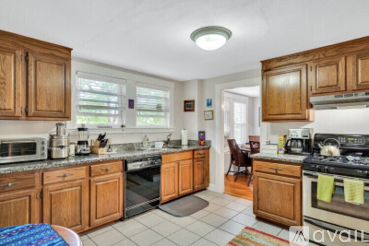 A kitchen with wooden cabinets and a white countertop.