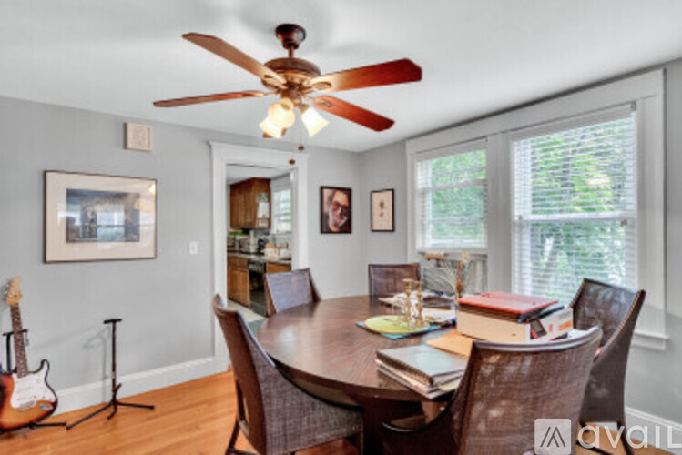 A dining room with a wooden table and chairs.