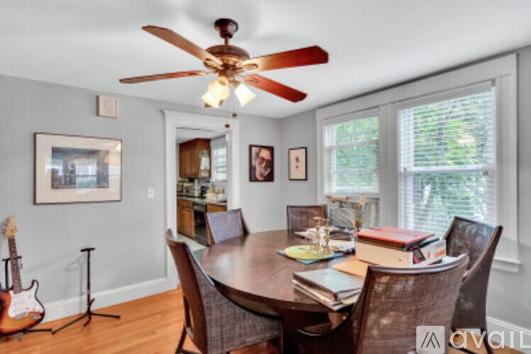 A dining room with a wooden table and chairs.
