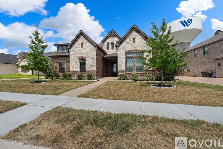 A large house with a driveway in front of it.