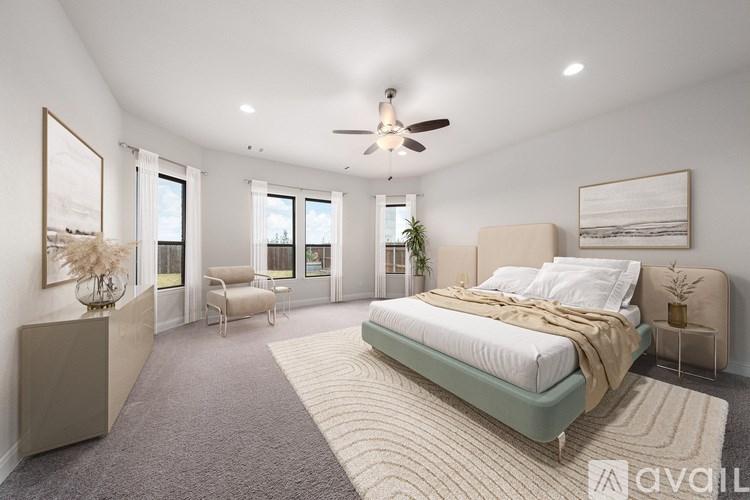 A bedroom with a large bed and a ceiling fan.