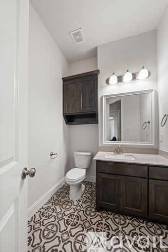 A bathroom with a black and white floor.