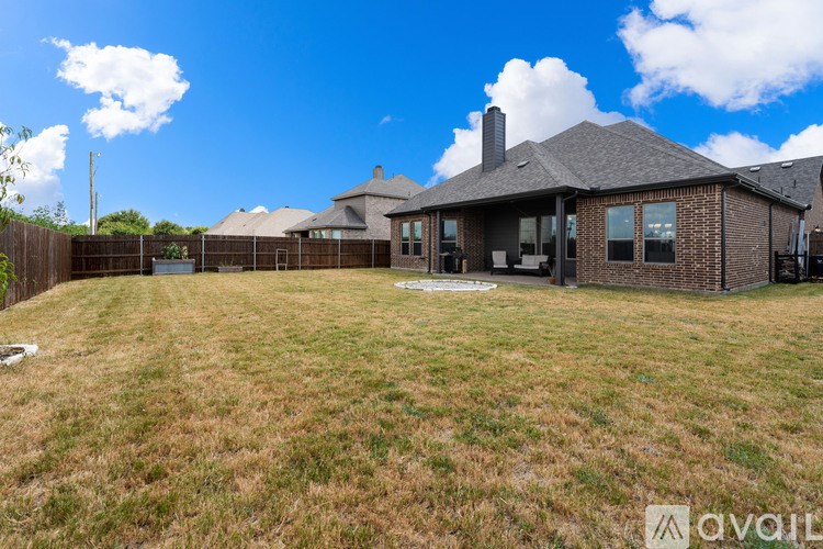 A house with a large yard is for sale.