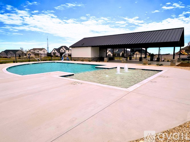 A pool with a black roof and a fountain in the middle.