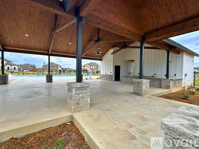 A covered patio area with a pool in the background.