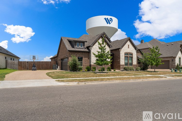 A large house with a water tower on top of it.