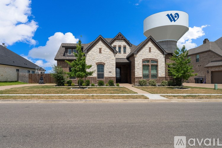 A large house with a water tower in the background.