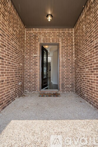 A brick wall with a doorway and a window.