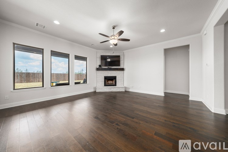A spacious living room with a fireplace and a television.