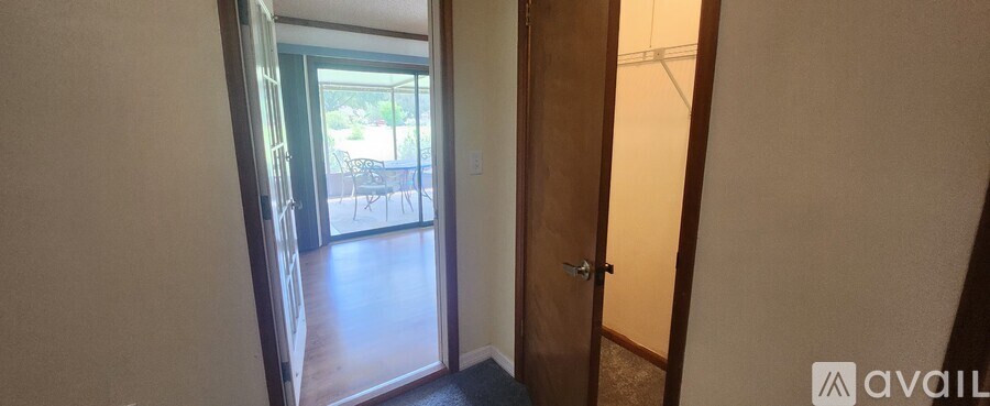 A hallway with a door leading to a balcony.