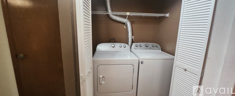 A small laundry room with a washer and dryer.