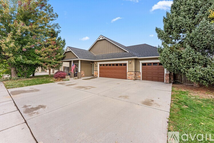 A house with a garage and a driveway is for sale.