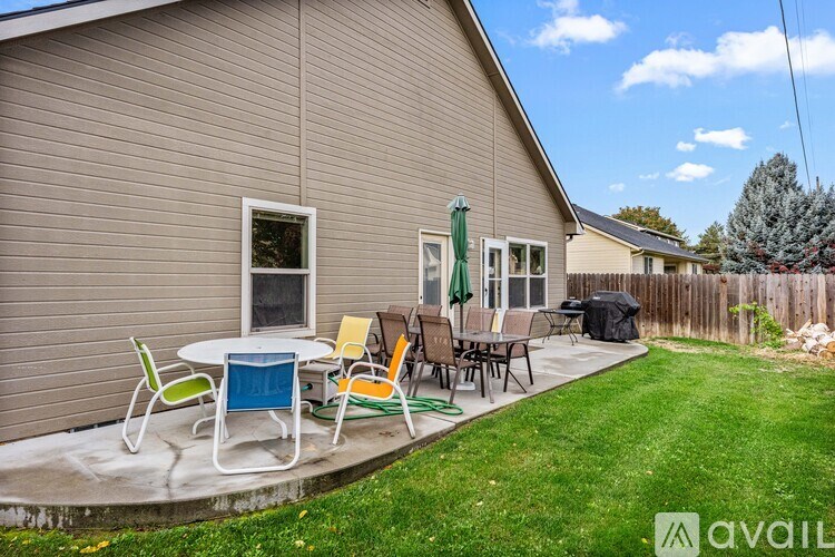 A house with a patio and lawn chairs.