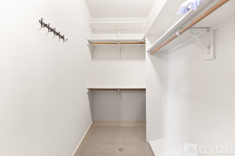 A small, empty room with a coat rack on the wall.