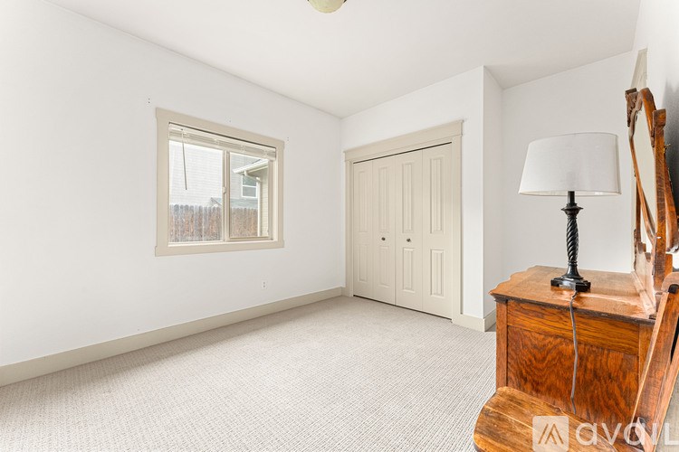 A room with a wooden table and a lamp on it.