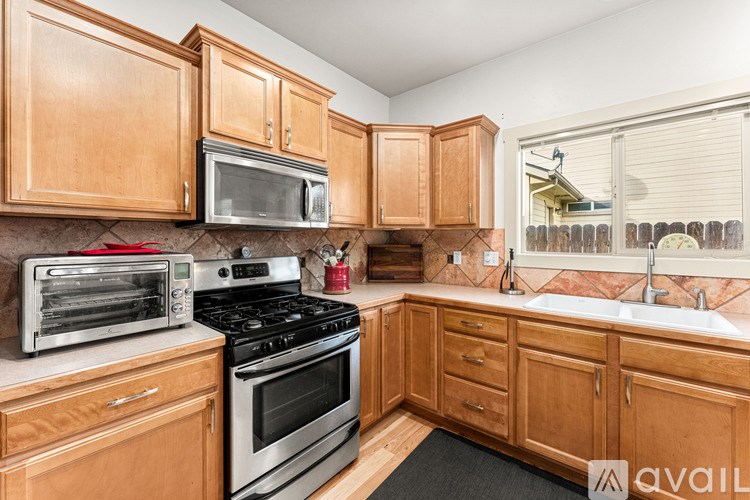 A kitchen with wooden cabinets and stainless steel appliances.