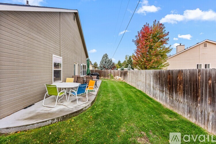 A backyard with a table and chairs.