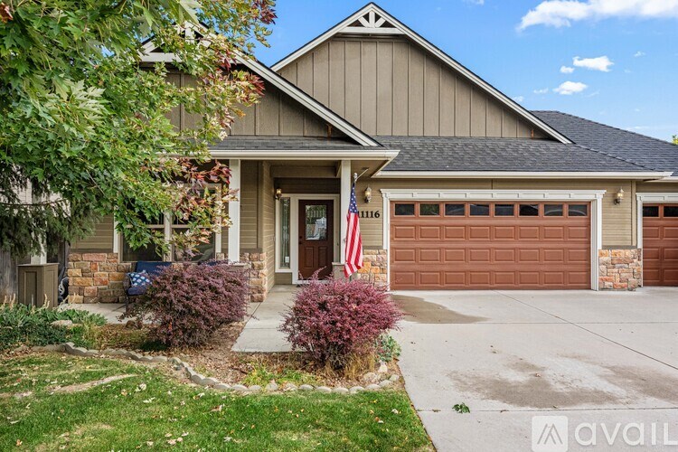 A house with a brown garage door and a flag on the front.