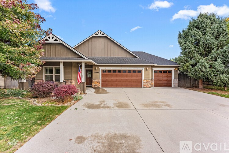 A house with a brown garage door and an American flag on the front.