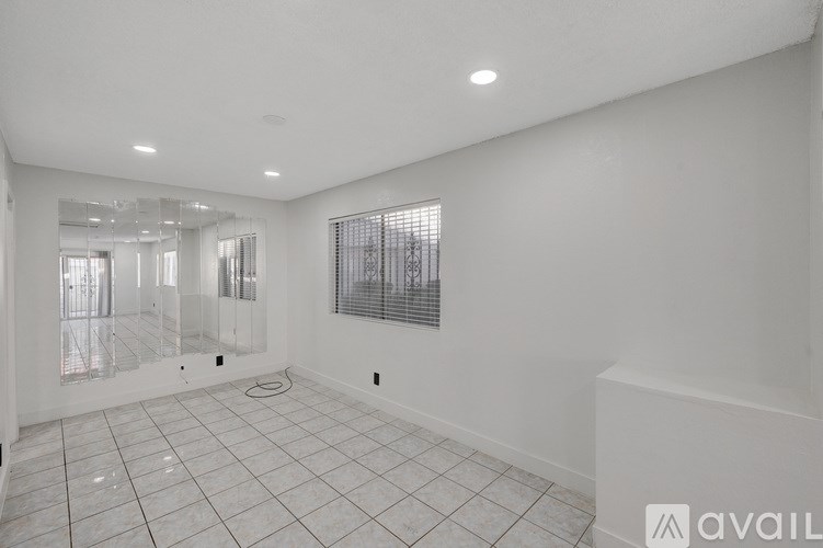 A spacious bathroom with a walk-in shower and a toilet.