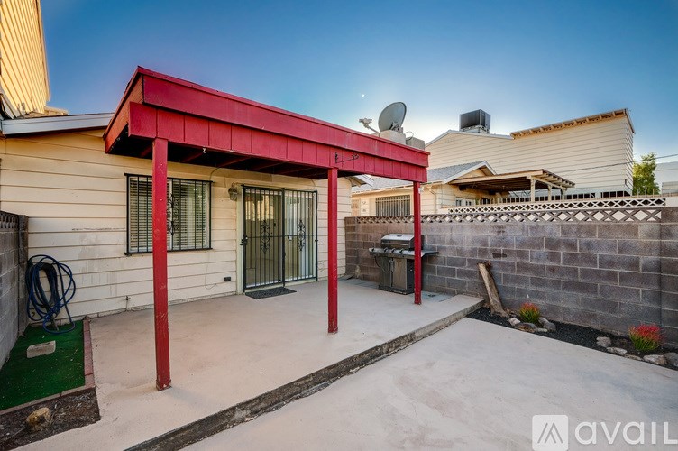 A house with a red awning and a satellite dish on the roof.