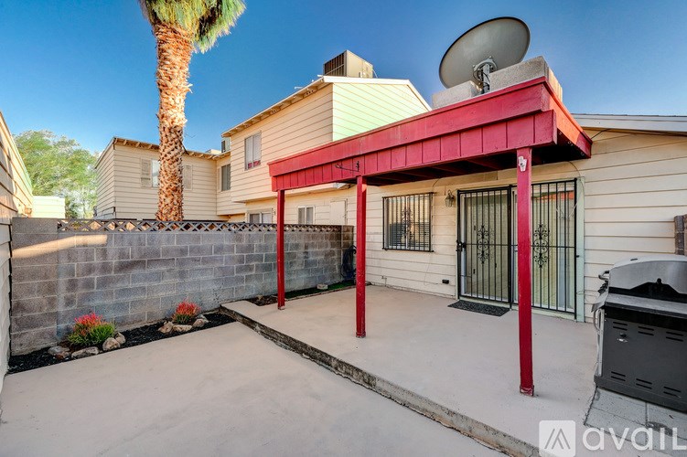 A house with a red awning and a satellite dish on the roof.