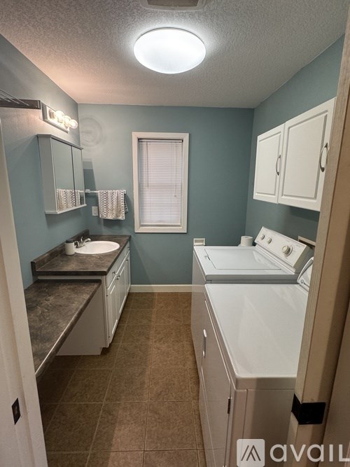 A bathroom with a washer and dryer.