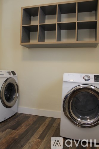 Two front load washing machines in a laundry room.