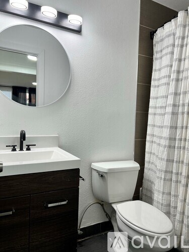 A white toilet sits next to a sink in a bathroom.