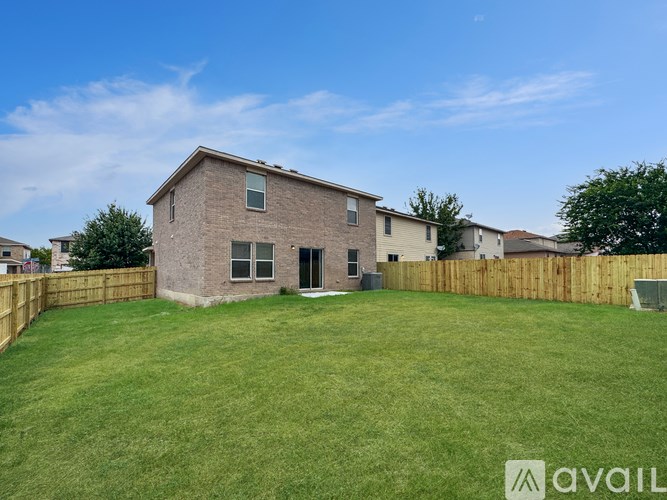 A house with a fenced yard is for sale.