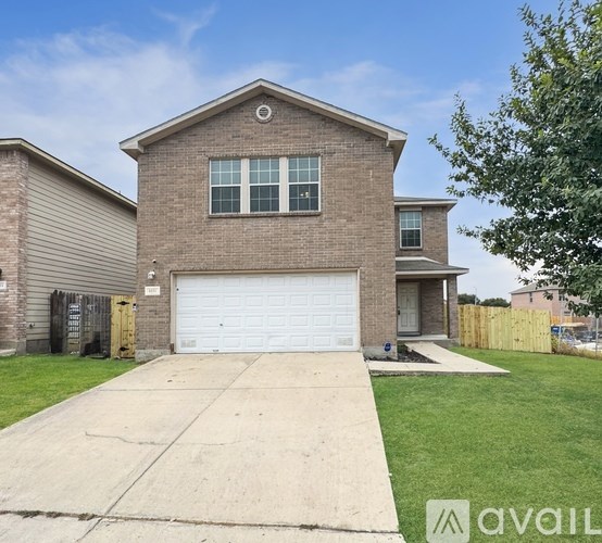A two-story house with a garage is available for sale.