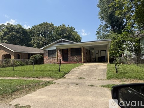 A house with a driveway and a car parked in front.
