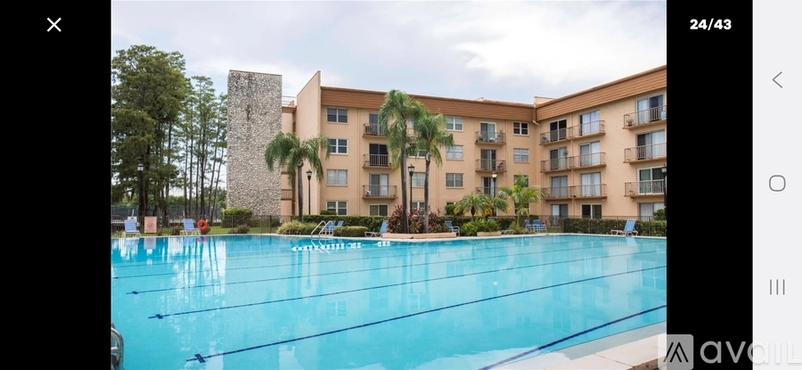 A large swimming pool in front of a multi-story building.