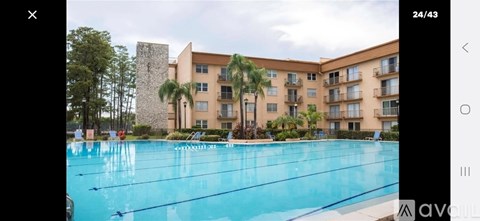 A large swimming pool in front of a multi-story building.