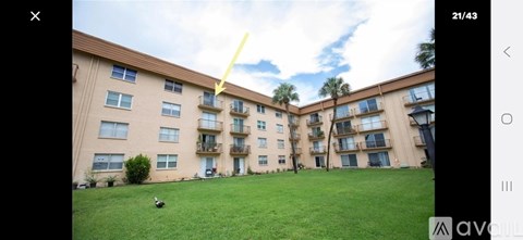 A grassy area in front of apartment buildings.