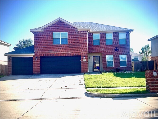 A red brick house with a black garage door.